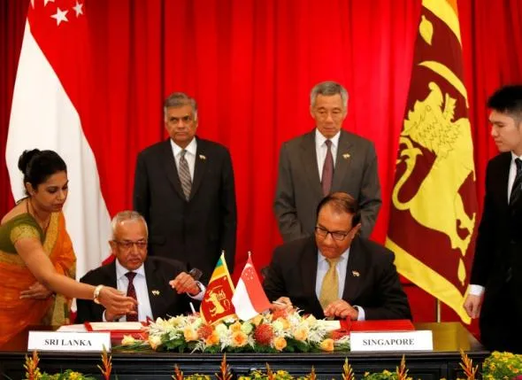 Sri Lanka’s Prime Minister Ranil Wickremesinghe and Singapore’s Prime Minister Lee Hsien Loong witness a Memoranda of Understanding signing ceremony at the Istana in Singapore